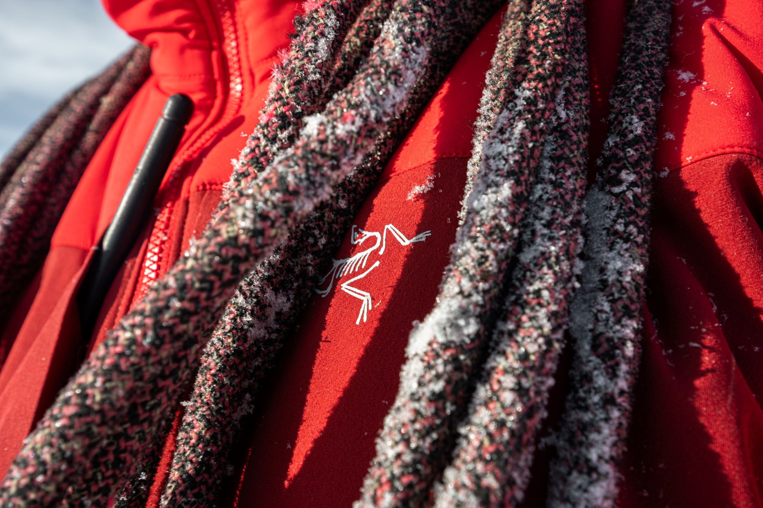 Close up of Arc’teryx PRO jacket with rope covered in frost during alpine use